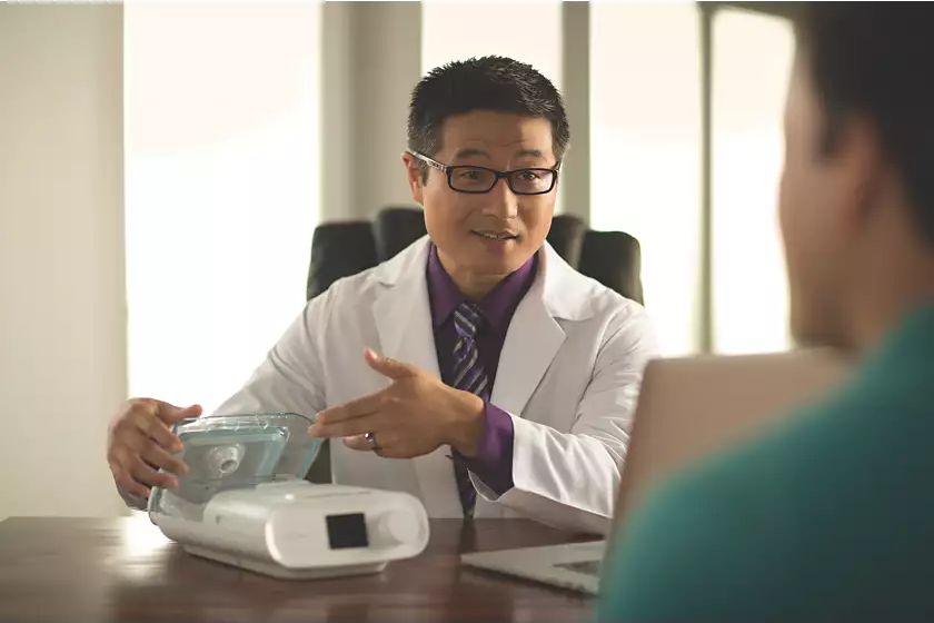 Healthcare provider helping the patient with a Philips Respironics DreamStation Auto CPAP