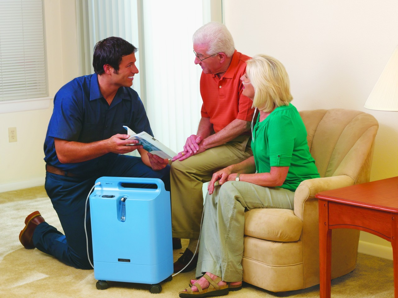 Health care provider demonstrating the Philips Respironics Oxygen Concentrator to a patient at home